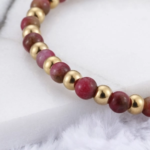 Minimalist gold titanium steel beaded bracelet with red garnet stones in luxury setting