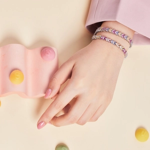 Close-up of vibrant S925 sterling silver bracelets with colorful zircon stones on a model
