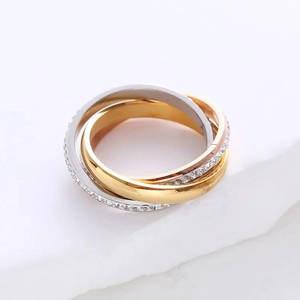 Three-tone interlocking rolling ring with crystals in gold, rose gold and silver finish