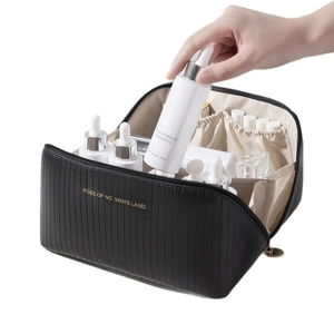 Black striped vanity bag with gold text featuring large capacity and vertical texture
