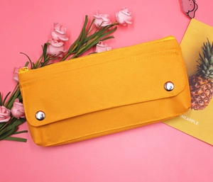 Detail of orange high-elastic oxford fabric pencil case with metal snap buttons and zipper