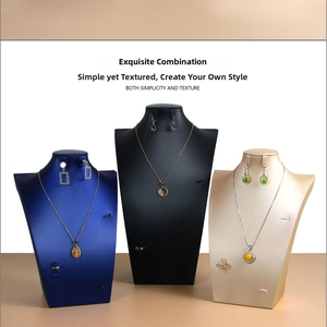 Detailed view of jewelry display busts in navy blue, black, and champagne gold finishes
