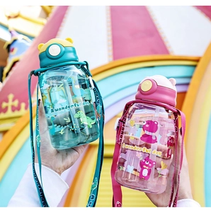 Close-up of cute cartoon dinosaur and bear straw water bottles with portable straps