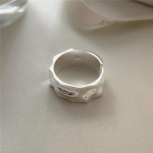 Macro view of S925 sterling silver ring showing irregular lava texture and hallmark
