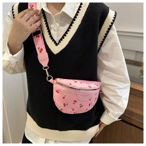Detailed close-up of a pink waist bag featuring a trendy cherry print and fabric strap