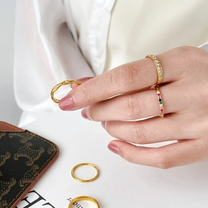 Close-up of gold titanium rings with rainbow cubic zirconia and hexagram detail