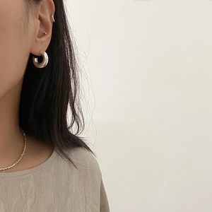 Minimalist thick silver C-shape hoop earrings and bead chain necklace on model