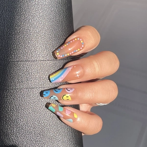 Rainbow polka dot smiley face press-on nails with long coffin shape on hand