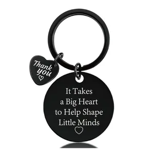 Detail of black stainless steel keychain with heart pendant and engraved teacher thank you text