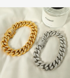 Detail of gold and silver cuban link bracelets with sparkling crystal pavé settings