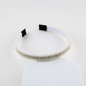 Elegant white pearl and rhinestone braided headband shown at a 45-degree angle