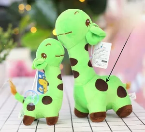 Detailed view of two green spotted giraffe plush toys with suction cups and labels