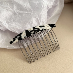 Detail of tortoise shell acetate hair comb with ten durable metal teeth for styling