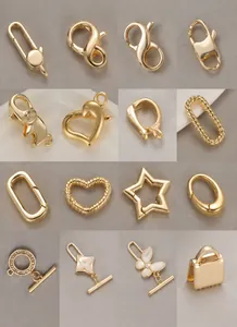 Golden DIY jewelry components showing lobster clasps and star buckles on grey background