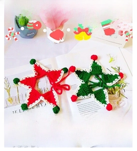Detail of red and green crochet star pet collars with plush pom-poms for Christmas