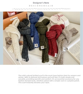 Detailed close-up of knitted wool scarves in various colors with textured cable stitch pattern
