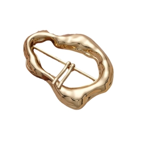 Minimalist irregular wavy golden metal buckle for coats and scarves on white background