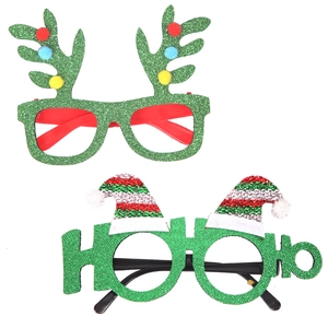 Detail of Christmas glasses featuring green glitter reindeer antlers and HO HO HO letters