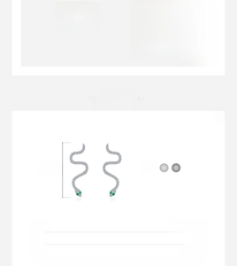 Detailed macro view of S925 sterling silver snake earrings with green gemstone eyes