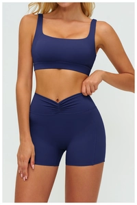 Detail of navy blue sports set featuring a V-shaped ruched high-waist band on matte shorts