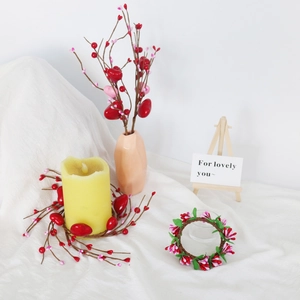 Pink and red berry candle ring wreath on brown vines for Valentines day table decor