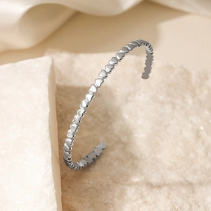 Minimalist 18K gold plated stainless steel open bangle with continuous heart pattern design