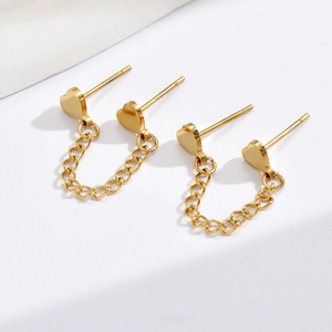 Detailed view of golden heart-shaped stud earrings with chain link connector in steel