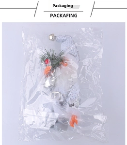 Detailed view of Santa Claus sequin ornament with golden bell in packaging