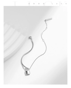 Detail of silver S925 padlock pendant with elegant box chain on white minimalist background