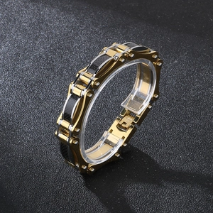 Close-up of gold plated steel motorcycle bracelet with black carbon fiber link inlay