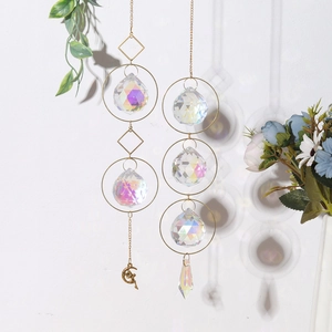 Macro detail of AB suncatcher prisms showing rainbow light refraction on white wall