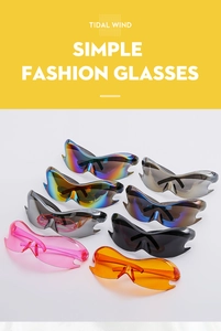 Flat lay display of colorful Y2K futuristic wrap-around sunglasses in multiple vibrant hues