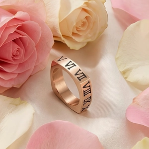 Dettaglio dell'anello quadrato in oro rosa con numeri romani su sfondo di seta