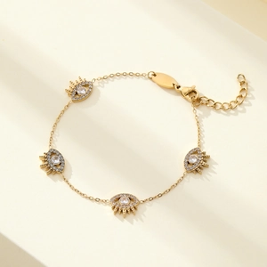 Gold evil eye bracelet with four zircon pendants, lobster clasp and extension chain