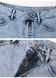 Détails d'un jean bleu clair montrant le bouton à la taille et la fermeture éclair