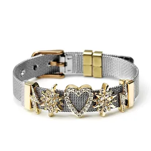 Detail of silver mesh steel bracelet with golden heart charm and star pendants
