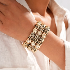 Detail shot of vintage wide gold cuff bracelet with sparkling rhinestones on model