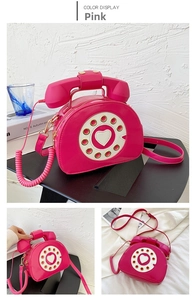 Detail of pink patent leather crossbody bag in vintage rotary telephone creative design