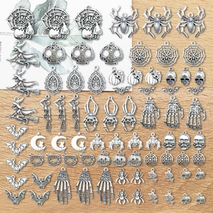 Detailed view of silver Halloween charms including skulls, bats and pumpkin for DIY jewelry