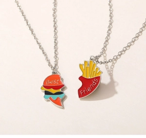 Detail of Best Friends necklace set featuring enamel burger and fries shaped pendants
