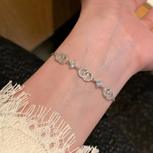 Macro shot of silver intertwined rings bracelet with sparkling cubic zirconia stones