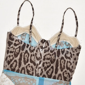 Close-up of leopard print chiffon dress with white lace hem and elegant V-neckline