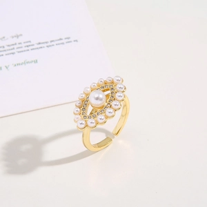 Detailed view of evil eye ring featuring pearls and zircons on gold adjustable band