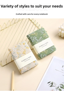 Close-up of A6 linen notebooks with floral embroidery and elegant decorative stationery