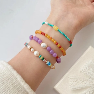 Detailed view of bohemian beaded bracelet set featuring freshwater pearls on wrist