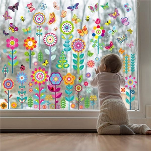 Toddler by window showing double-sided floral butterfly spring decals decoration