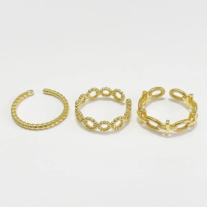 Three-piece gold adjustable S925 sterling silver twist and wave rings set on white background