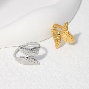 Macro detail of adjustable leaf-shaped rings in gold and silver stainless steel finish