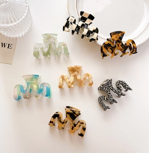 Flat lay showing various acetate hair clips in tortoiseshell and marble patterns