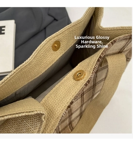Detail of canvas tote featuring brown plaid fabric and gold magnetic snap closures